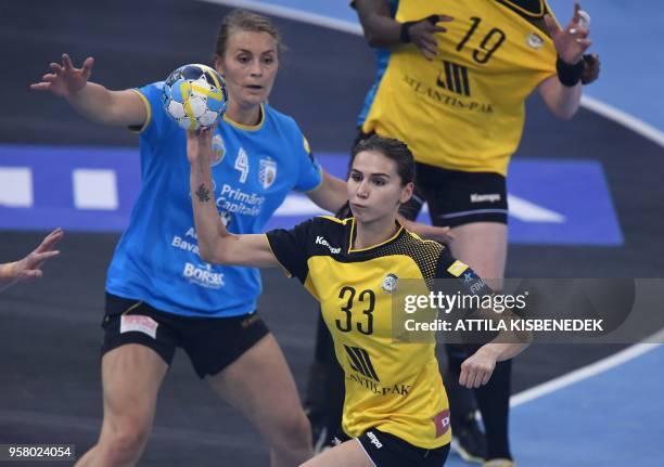 Ekaterina Ilina of Russian Rostov-Don passes the ball in front of Isabelle Gulldén of CSM Bucuresti during the bronze match of the EHF Women's...