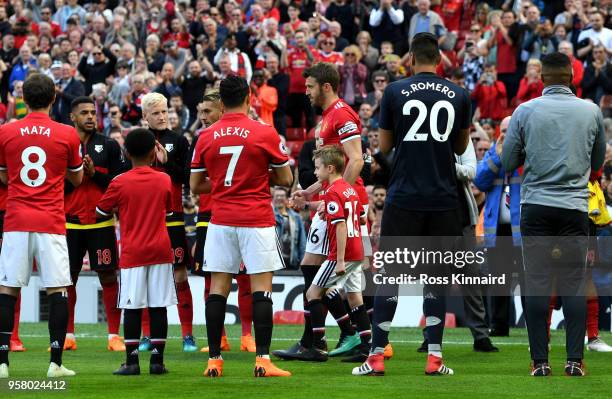 Michael Carrick of Manchester United leads out the team prior to the Premier League match between Manchester United and Watford at Old Trafford on...