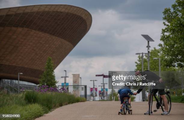 Man helps his son on to a bicycle in front of the Velodrome at Olympic Park as it is announced that Dame Tessa Jowell has died on May 13, 2018 in...