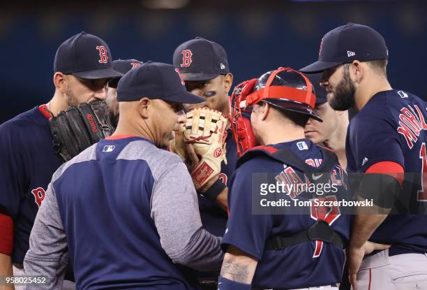 Manager Alex Cora of the Boston Red Sox pays a visit to the mound to talk to Matt Barnes and Xander Bogaerts and Christian Vazquez and Mitch Moreland...