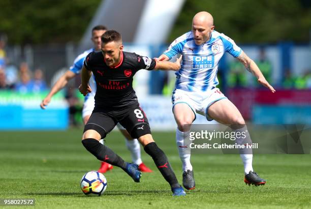 Aaron Ramsey of Arsenal battles for possession with Aaron Mooy of Huddersfield Town during the Premier League match between Huddersfield Town and...