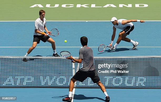 Marcus Daniell of New Zealand and Horia Tecau of Romania play up at the net against Marcelo Melo and Bruno Soares of Brazil during day six of the...