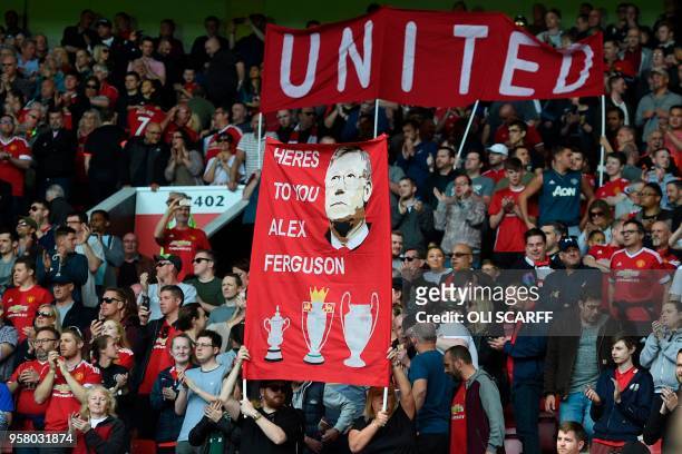 Banner wishing former manager Alex Ferguson, who is convalescing after having emergency surgery on a brain haemorrhage, is seen during the English...