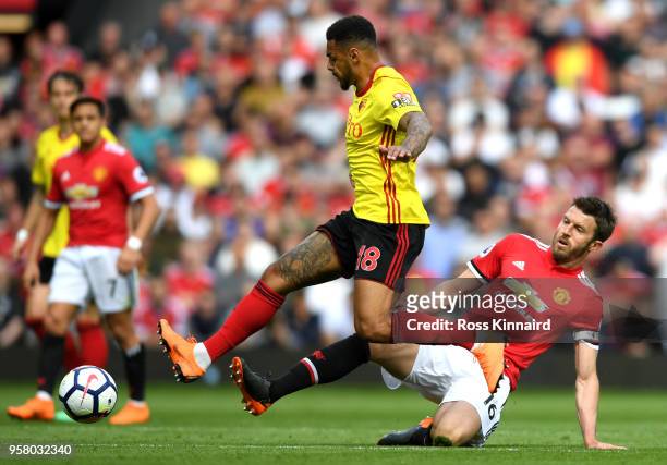 Andre Gray of Watford battles for possession with Michael Carrick of Manchester United during the Premier League match between Manchester United and...