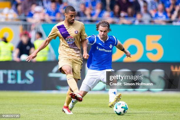 Malcolm Cacutalua of Aue is challenged by Yannick Stark of Darmstadt during the Second Bundesliga match between SV Darmstadt 98 and FC Erzgebirge Aue...