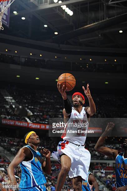 Richard Hamilton of the Detroit Pistons goes up for a shot attempt against James Posey of the New Orleans Hornets in a game at the Palace of Auburn...