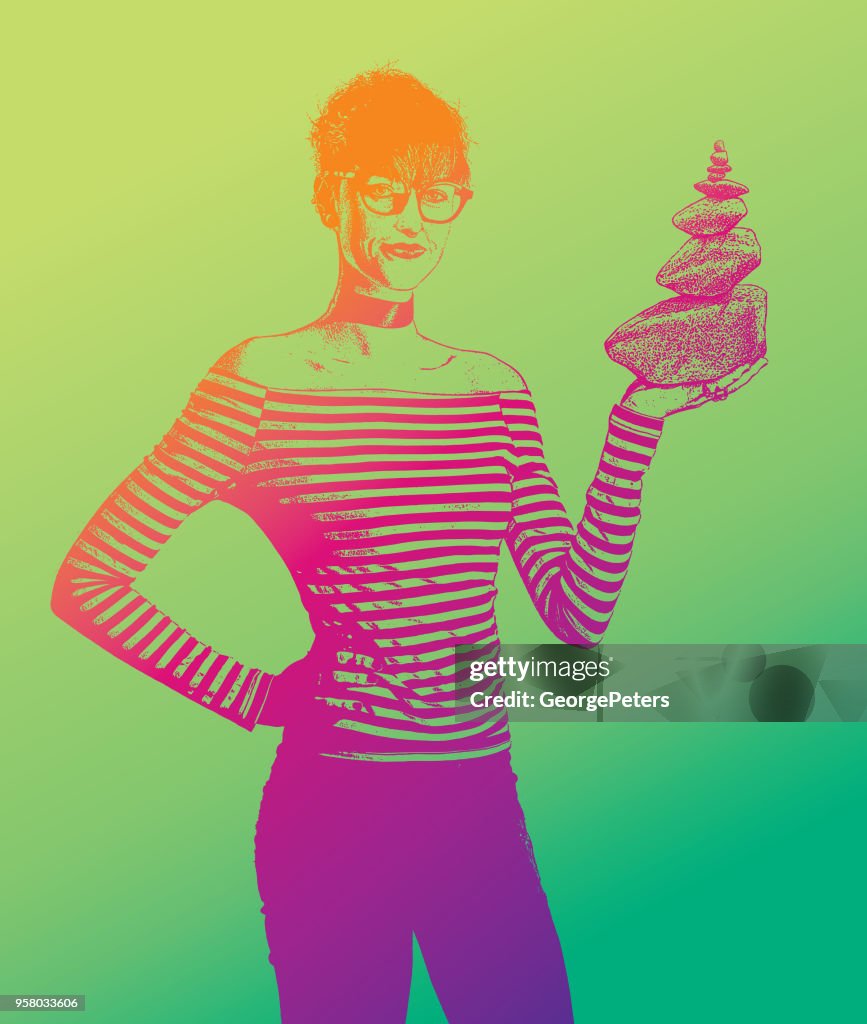 Businesswoman holding rock cairn
