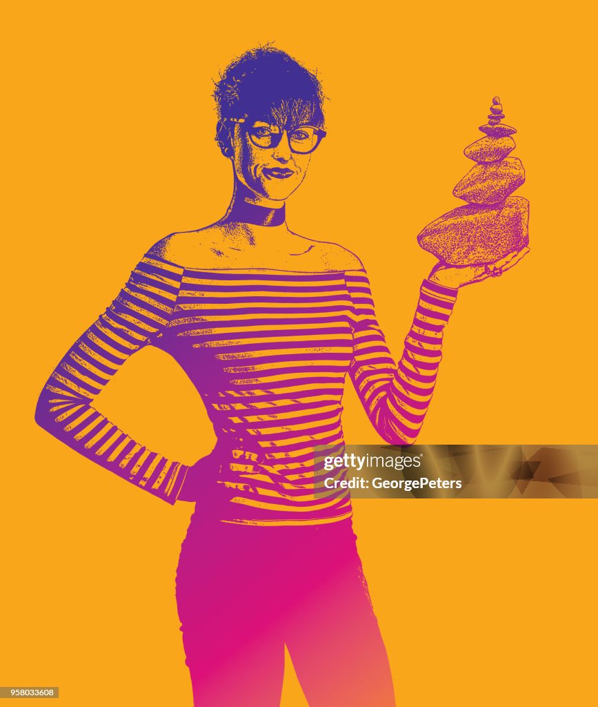 Businesswoman holding rock cairn