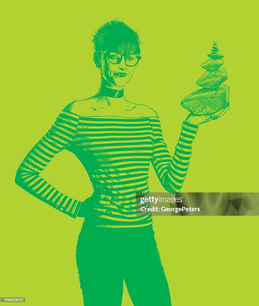 Businesswoman holding rock cairn