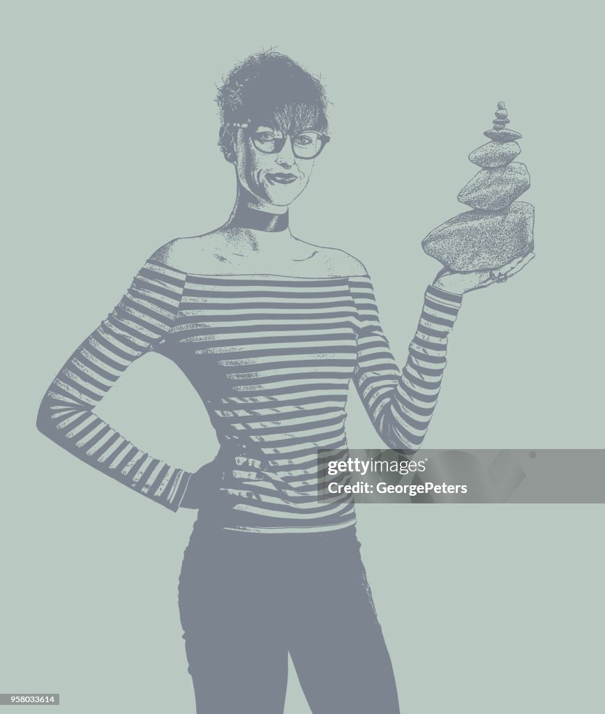 Businesswoman holding rock cairn