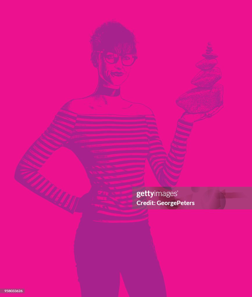 Businesswoman holding rock cairn