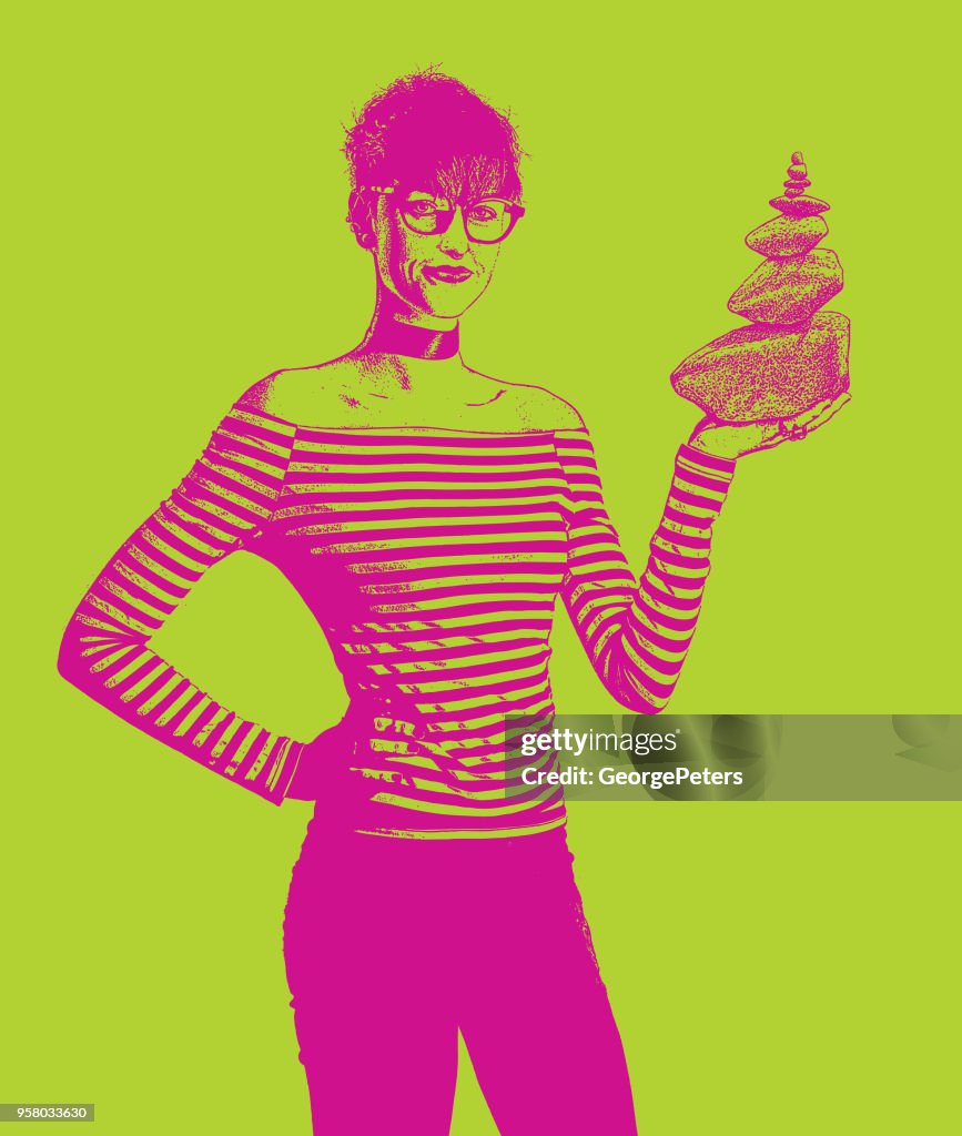 Businesswoman holding rock cairn