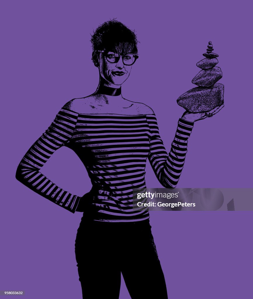 Businesswoman holding rock cairn