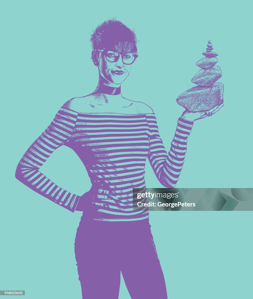 Businesswoman holding rock cairn