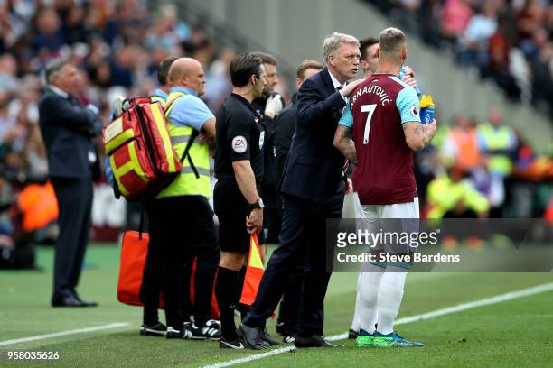 David Moyes, Manager of West Ham United talks to Marko Arnautovic of West Ham United during the Premier League match between West Ham United and...