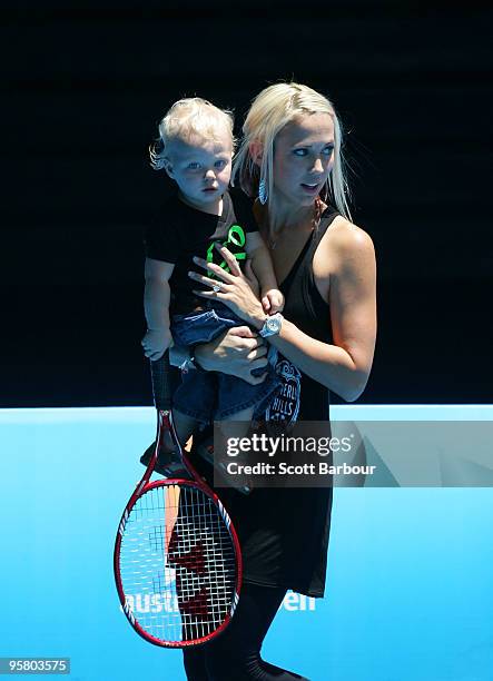 Australian actress Bec Cartwright holds her son Cruz Lleyton Hewitt as they watch Lleyton Hewitt of Australia during a practice session ahead of the...