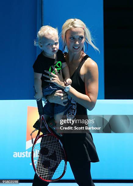 Australian actress Bec Cartwright holds her son Cruz Lleyton Hewitt as they watch Lleyton Hewitt of Australia during a practice session ahead of the...