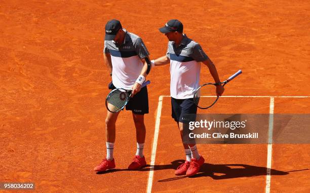 Bob Bryan of the United States is helped off court by Mike Bryan of the United States after receiving an injury playing against Nikola Mektic of...