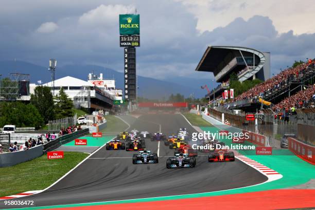 Lewis Hamilton of Great Britain driving the Mercedes AMG Petronas F1 Team Mercedes WO9 leads the field at the start during the Spanish Formula One...