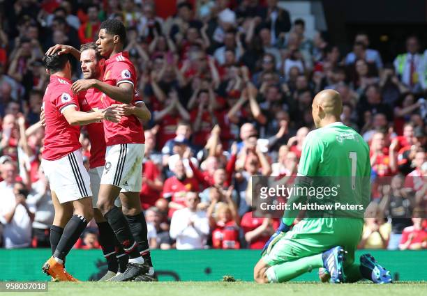 Marcus Rashford of Manchester United celebrates scoring their first goal during the Premier League match between Manchester United and Watford at Old...