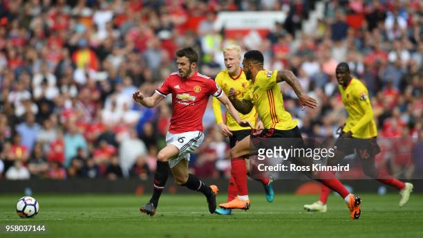 Michael Carrick of Manchester United and Andre Gray of Watford battle for possession during the Premier League match between Manchester United and...