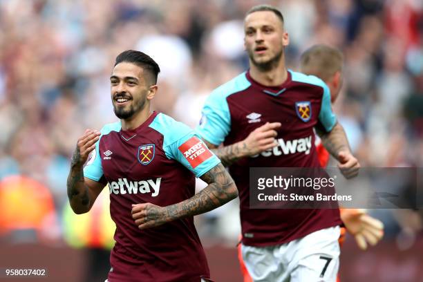 Manuel Lanzini of West Ham United celebrates after scoring his sides first goal and Marko Arnautovic of West Ham United looks on during the Premier...