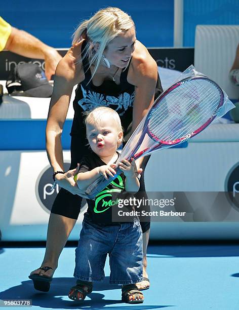 Australian actress Bec Cartwright holds her son Cruz Lleyton Hewitt as they watch Lleyton Hewitt of Australia during a practice session ahead of the...