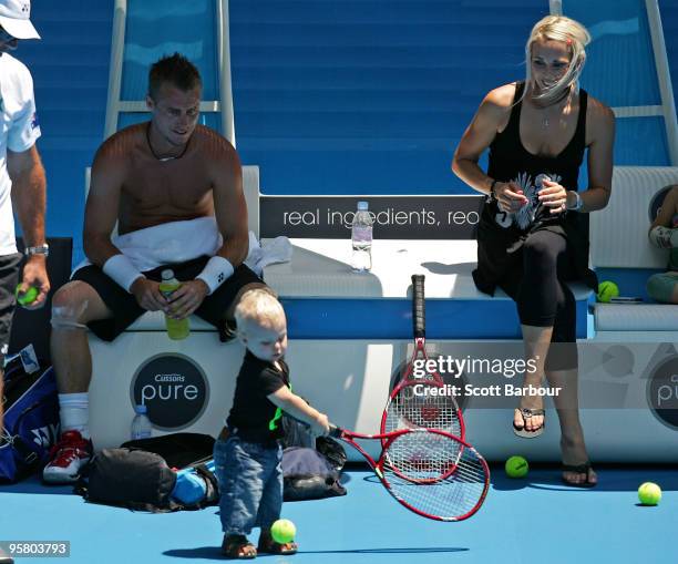 Australian actress Bec Cartwright and Lleyton Hewitt of Australia watch their son Cruz Hewitt during a practice session ahead of the 2010 Australian...