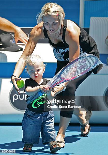 Australian actress Bec Cartwright holds her son Cruz Lleyton Hewitt as they watch Lleyton Hewitt of Australia during a practice session ahead of the...