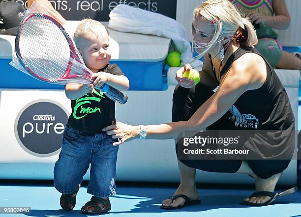 Australian actress Bec Cartwright holds her son Cruz Lleyton Hewitt as they watch Lleyton Hewitt of Australia during a practice session ahead of the...