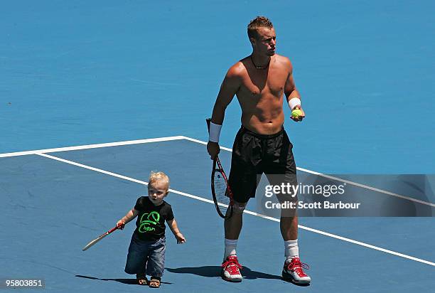 Lleyton Hewitt of Australia plays with his son Cruz Lleyton Hewitt during a practice session ahead of the 2010 Australian Open at Melbourne Park on...