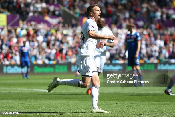 Andy King of Swansea City celebrates scoring his sides first goal of the game during the Premier League match between Swansea City and Stoke City at...