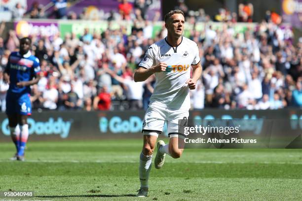 Andy King of Swansea City celebrates scoring his sides first goal of the game during the Premier League match between Swansea City and Stoke City at...