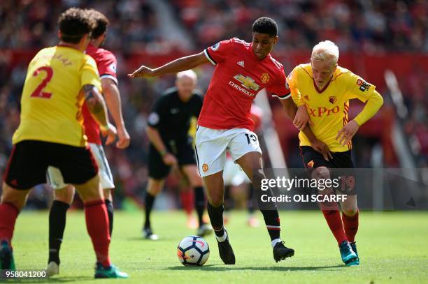 Manchester United's English striker Marcus Rashford takes on Watford's English midfielder Will Hughes during the English Premier League football...