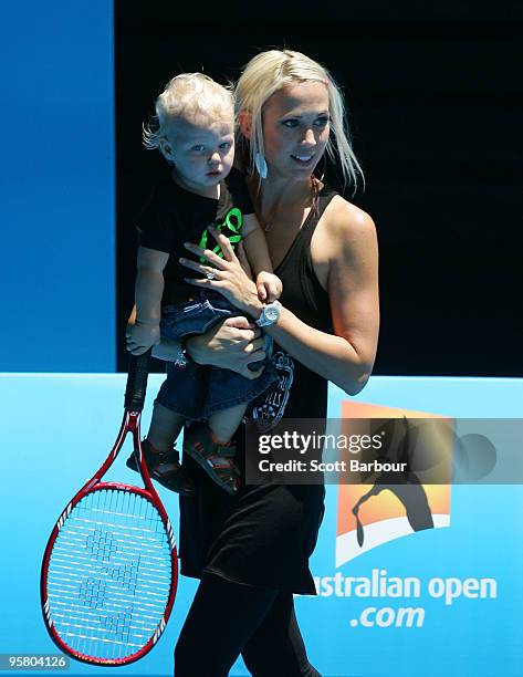 Australian actress Bec Cartwright holds her son Cruz Lleyton Hewitt as they watch Lleyton Hewitt of Australia during a practice session ahead of the...