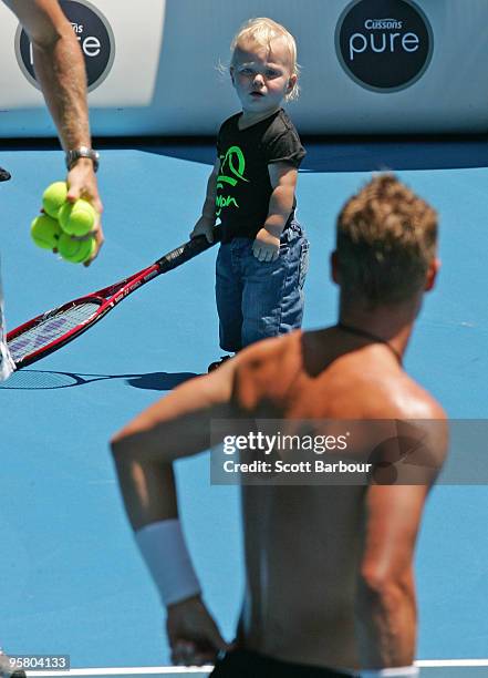 Cruz Hewitt watches his father Lleyton Hewitt of Australia during a practice session ahead of the 2010 Australian Open at Melbourne Park on January...