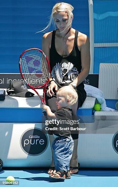 Australian actress Bec Cartwright watches her son Cruz Hewitt as Lleyton Hewitt of Australia practices ahead of the 2010 Australian Open at Melbourne...