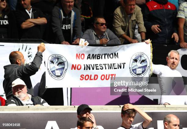 Fans hold up a sign reading 'No Ambition No Investment Sold Out!' prior to the Premier League match between Swansea City and Stoke City at Liberty...