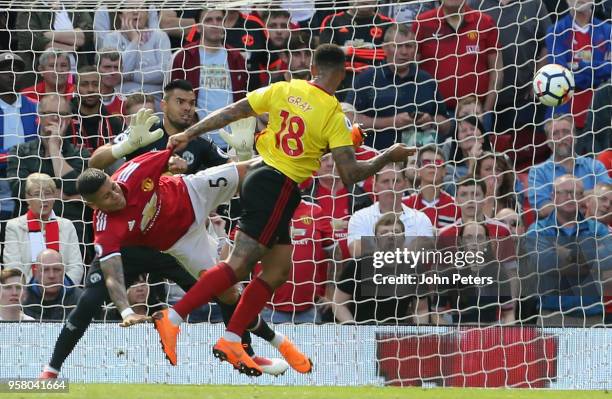 Marcos Rojo and Sergio Romero of Manchester United in action with Andre Gray of Watford during the Premier League match between Manchester United and...