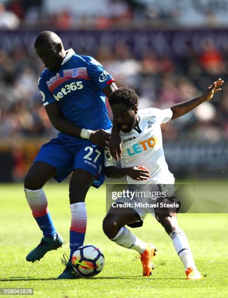 Badou Ndiaye of Stoke City battles for possession with Nathan Dyer of Swansea City during the Premier League match between Swansea City and Stoke...