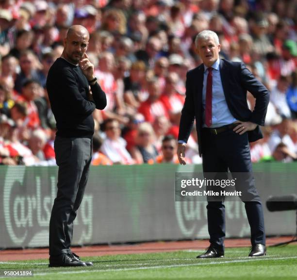 Josep Guardiola, Manager of Manchester City and Mark Hughes, Manager of Southampton looks on during the Premier League match between Southampton and...