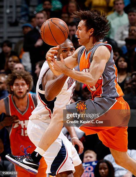 Al Horford of the Atlanta Hawks strips the ball from Steve Nash of the Phoenix Suns at Philips Arena on January 15, 2010 in Atlanta, Georgia. NOTE TO...