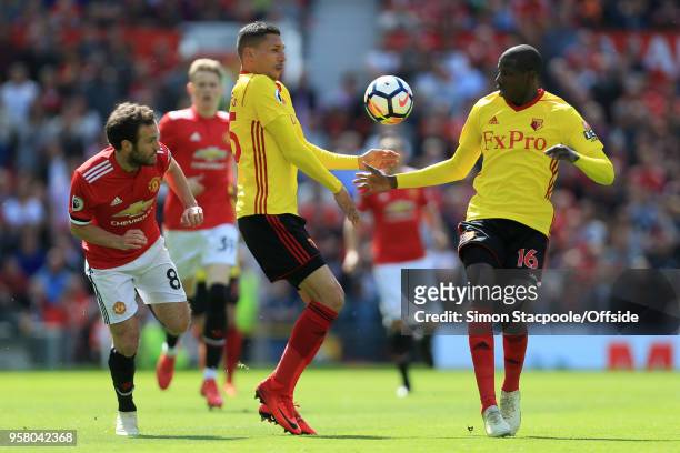 Juan Mata of Man Utd battles with Jose Holebas of Watford and Abdoulaye Doucoure of Watford during the Premier League match between Manchester United...
