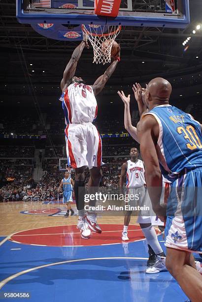 Ben Wallace of the Detroit Pistons goes up for a rebound over David West of the New Orleans Hornets in a game at the Palace of Auburn Hills on...