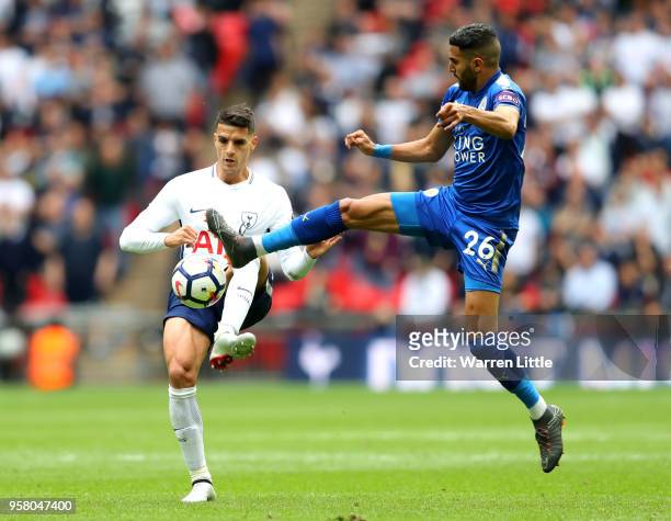 Erik Lamela of Tottenham Hotspur battles for possession with Riyad Mahrez of Leicester City during the Premier League match between Tottenham Hotspur...