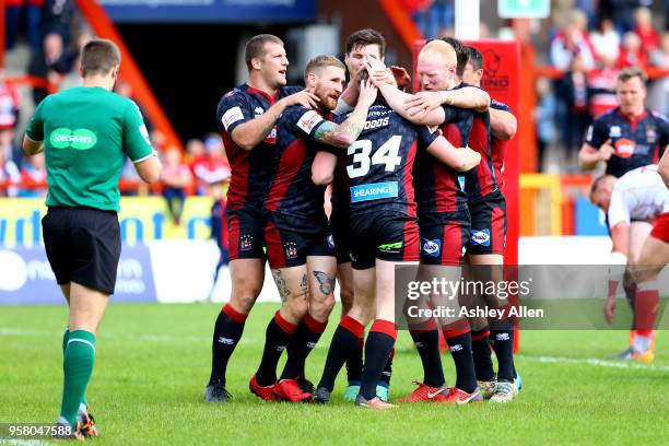 Wigan Warriors celebrate a try during round six of the Ladbrokes Challenge Cup at KCOM Craven Park on May 13, 2018 in Hull, England.