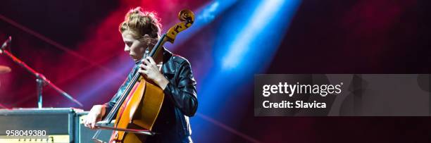 woman playing cello on the stage - cellist stock pictures, royalty-free photos & images