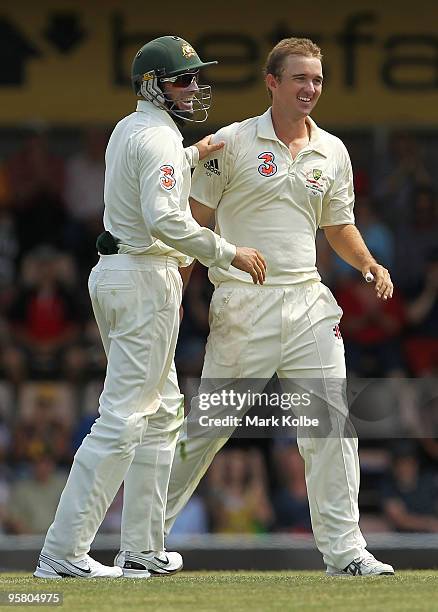 Michael Hussey and Nathan Hauritz of Australia celebrate after taking the wicket of Danish Kaneria of Pakistan during day three of the Third Test...