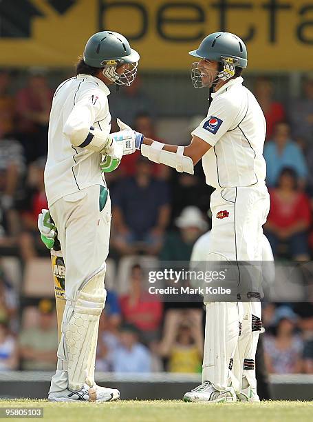 Mohammad Asif of Pakistan has his chest where he was hit by a short ball rubbed by Umar Gul of Pakistan during day two of the Third Test match...