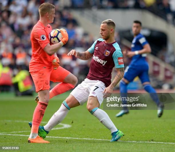 Marko Arnautovic of West Ham United is caught by Jordan Pickford of Everton during the Premier League match between West Ham United and Everton at...